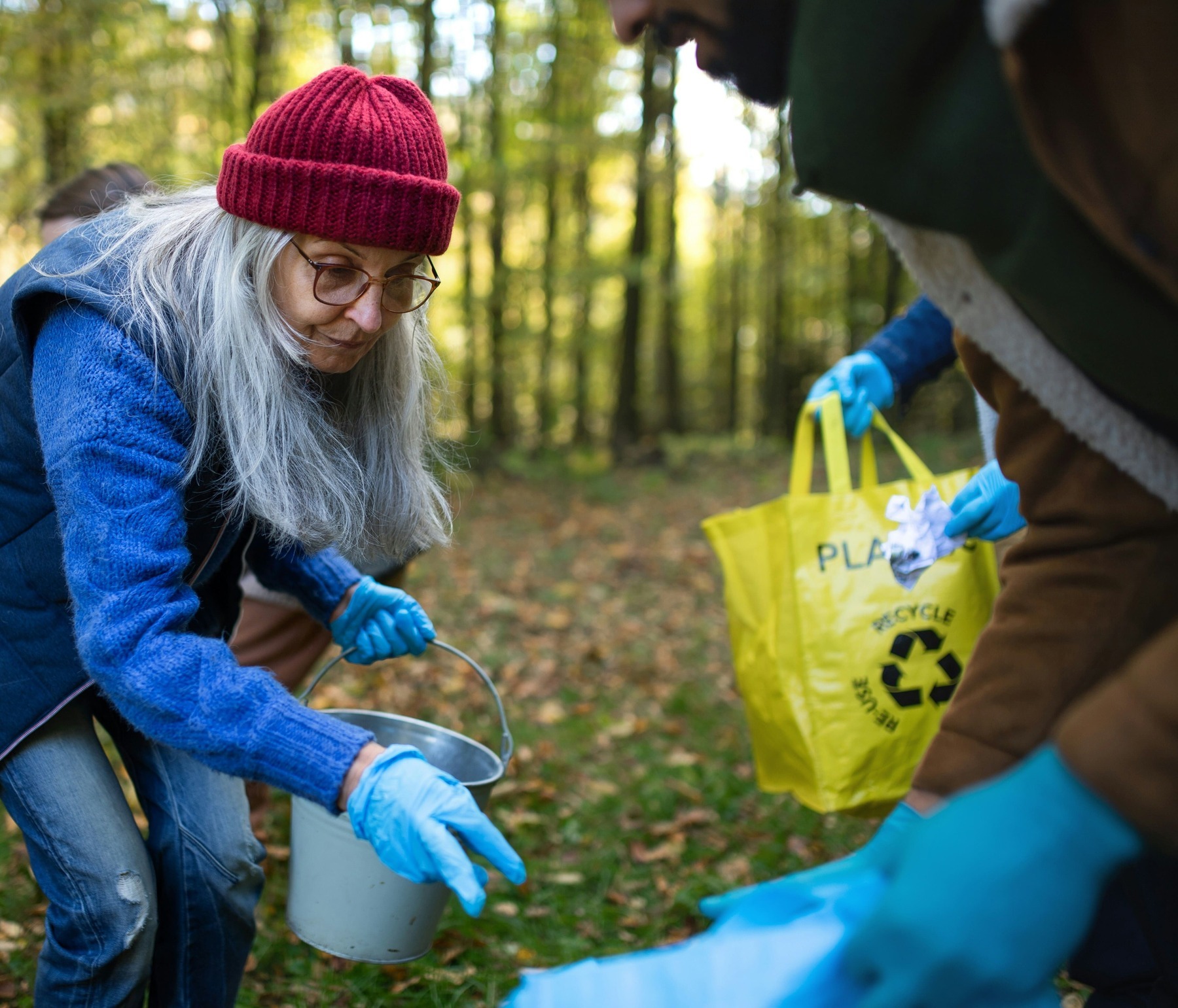 A Woman cleaning up the forest 