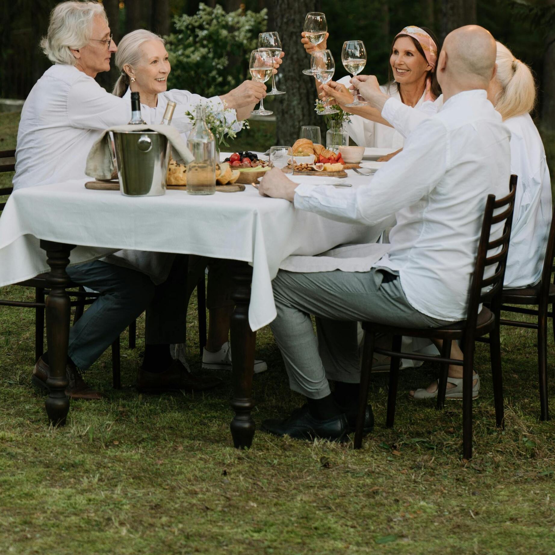 A group of people raising their glasses at a dinner table