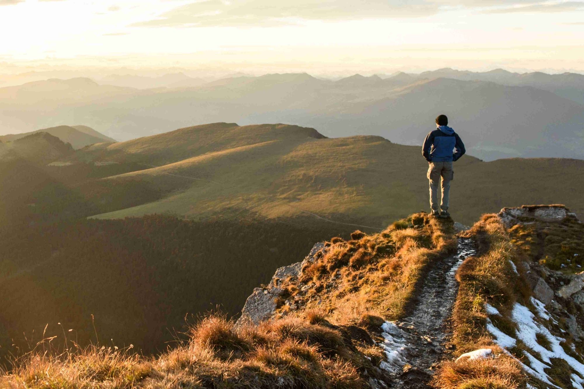Man standing atop a mountain