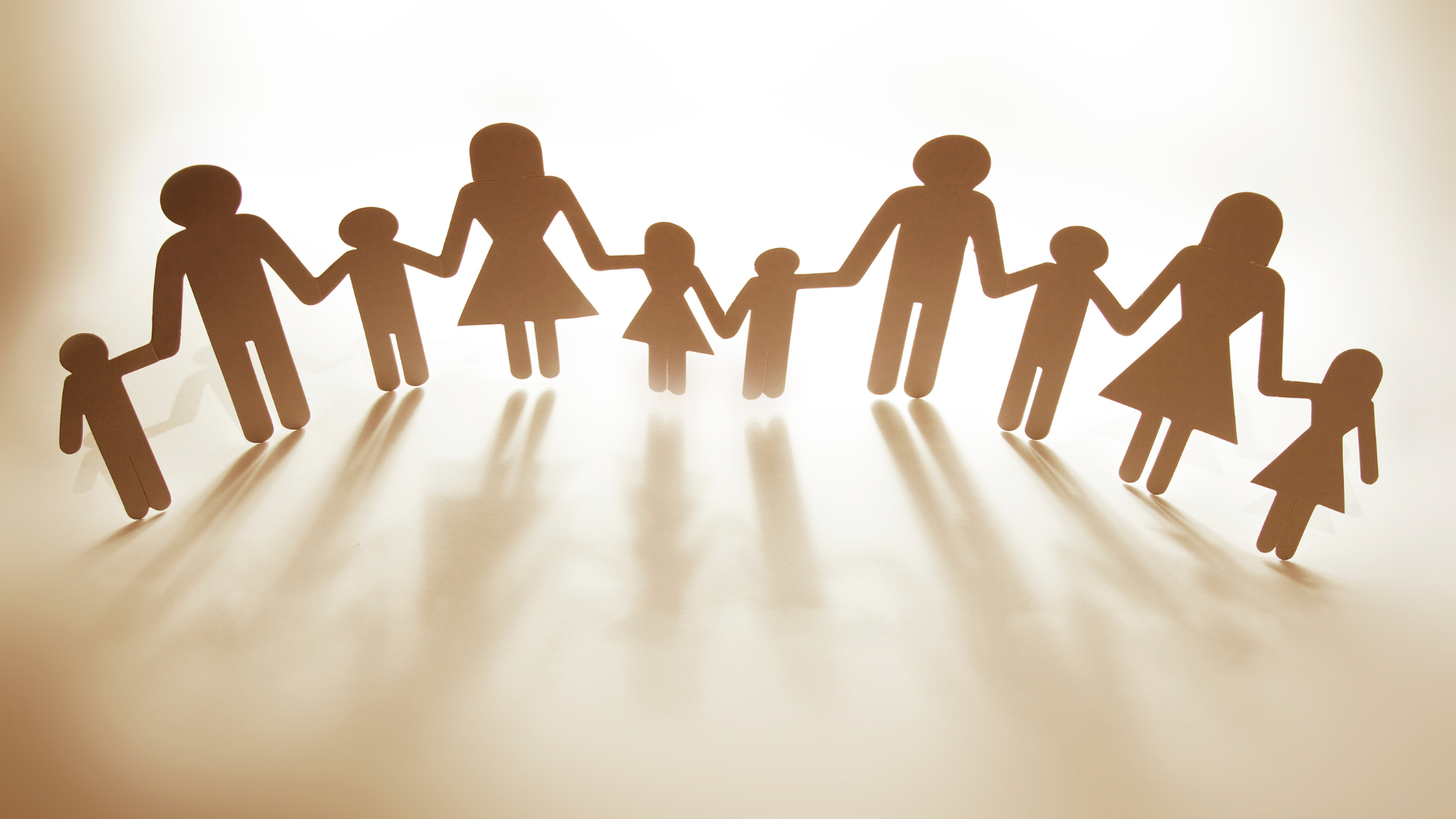 Paper cutouts of a family holding hands