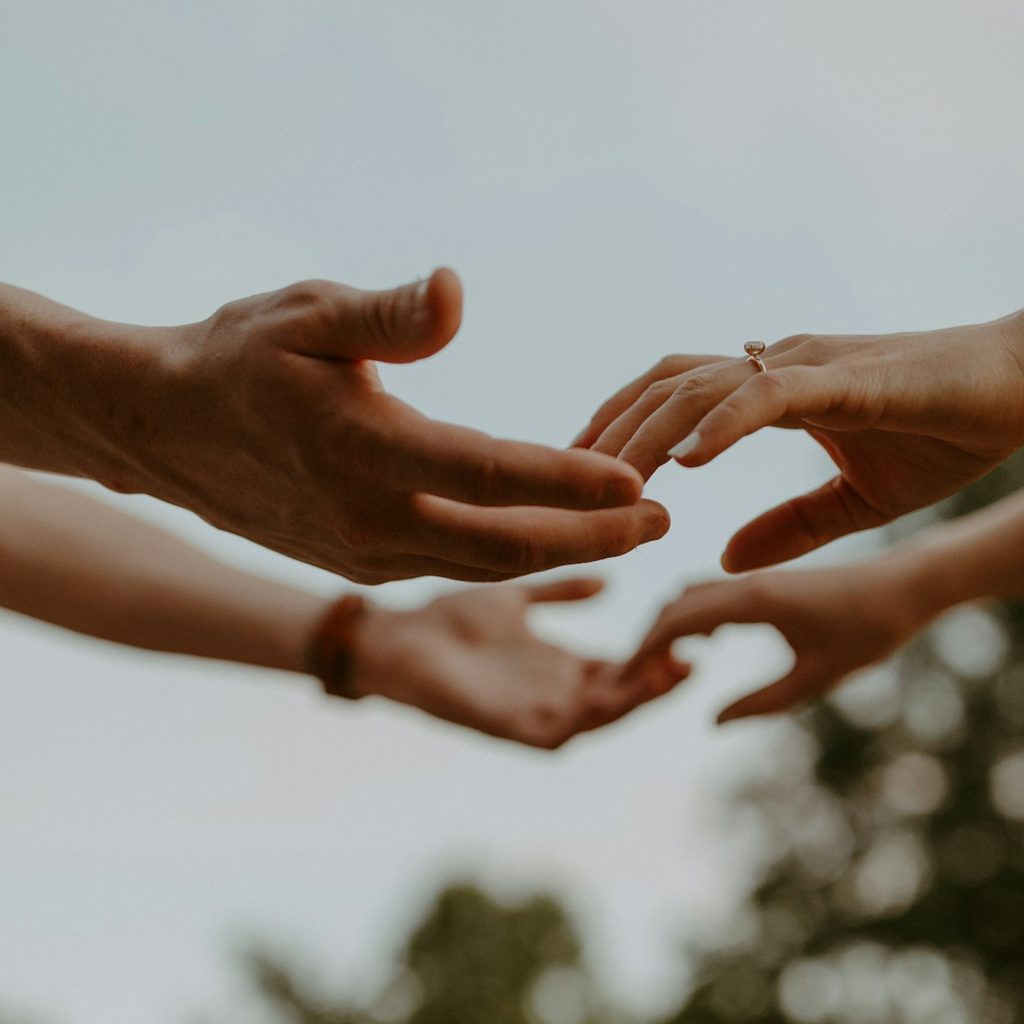 Two people holding each others hands
